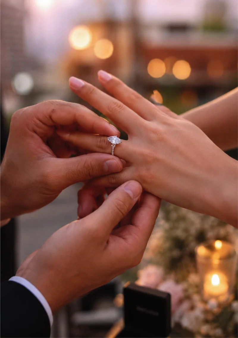 An engagement ring being placed on her finger